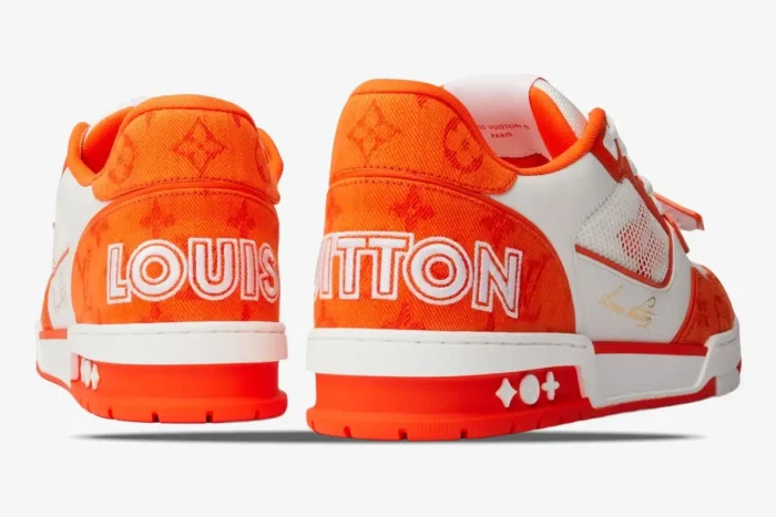 Rear view of Louis Vuitton Trainer Monogram Denim Orange sneakers with large white branding on the heels. - SKU 1A9ZBI