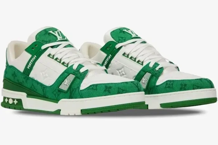 A pair of Louis Vuitton Trainer sneakers in green monogram denim and white, three-quarter front view. - SKU 1A9JHV-1A9JI1
