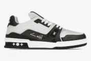 Louis Vuitton Trainer Sneaker Low #54 in black and white, side profile view on a white background. - SKU 1A9AD4