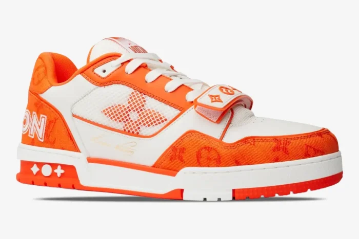 Side profile of a Louis Vuitton Trainer Monogram Denim Orange sneaker with white mesh and orange accents. - SKU 1A9ZBI