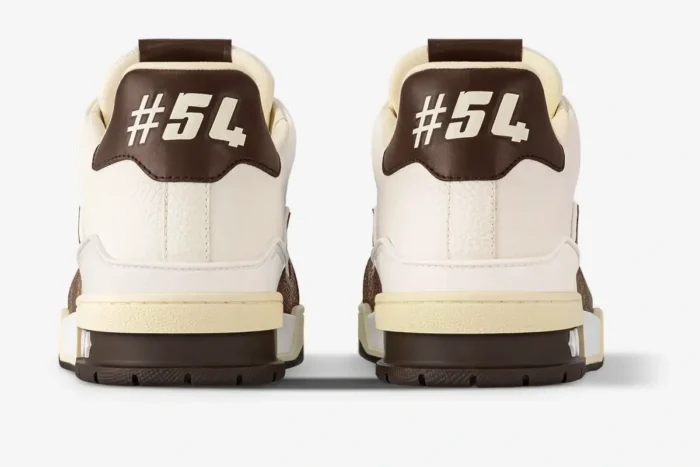 Rear view of Louis Vuitton Trainer sneakers in white and moka brown featuring #54 on the heel tab. - SKU 1ACV5P