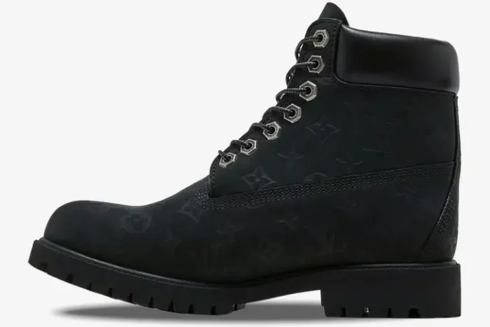 Side profile of a black Louis Vuitton x Timberland 6-inch ankle boot featuring an embossed monogram pattern. - SKU 1AD73H