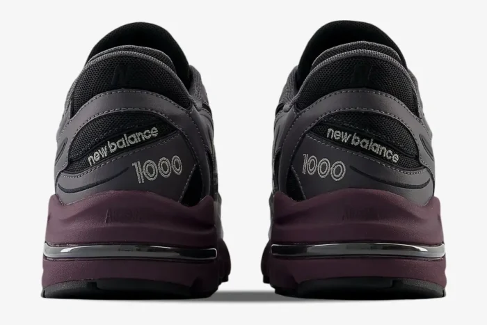 Rear view of New Balance 1000 sneakers in magnet grey and deep plum with embroidered heel details. - SKU M1000EB