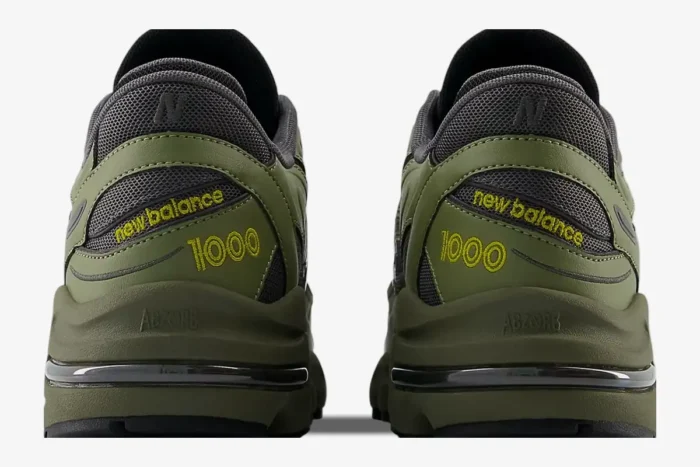 Rear view of New Balance 1000 Olivine Black Olive sneakers showing the embroidered heel branding. - SKU M1000EA