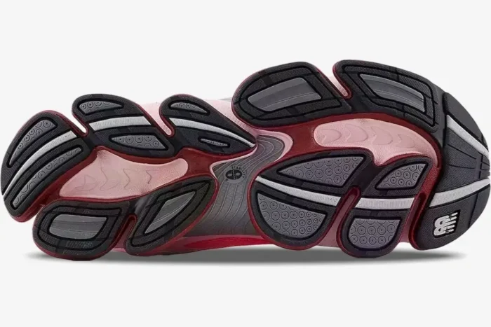 Underside view of New Balance 2000 Rose Sugar Monarch shoes displaying the pink and maroon traction pods. - SKU U9060WNA