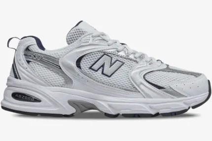 Side profile of a New Balance 530 sneaker in white, silver, and navy blue with mesh panels. - SKU MR530SG