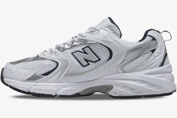 Side profile of a New Balance 530 sneaker in white, silver, and navy blue mesh and leather. - SKU MR530SG