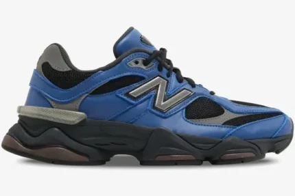 Side view of New Balance 9060 sneakers in Dark Royal Brown with blue leather and black mesh. - SKU U9060NRH