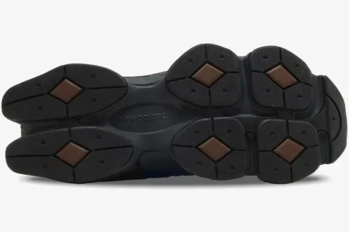 Bottom view of the New Balance 9060 Dark Royal Brown sneaker showing the black and brown podded outsole. - SKU U9060NRH