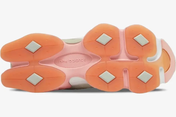 Bottom outsole view of New Balance 9060 Joe Freshgoods Penny Cookie Pink sneakers with orange pods. - SKU U9060JG1