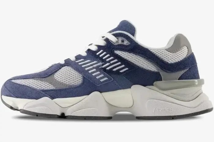 Side view of New Balance 9060 Natural Indigo sneakers featuring navy blue suede and chunky grey soles. - SKU U9060IND