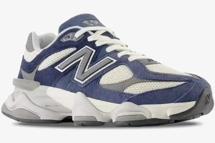 New Balance 9060 Natural Indigo sneaker in a side profile view with navy blue suede and cream mesh. - SKU U9060IND