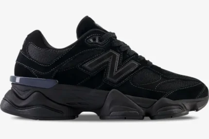 Side profile of New Balance 9060 Triple Black sneakers featuring a chunky sole and mesh upper. - SKU U9060BPM