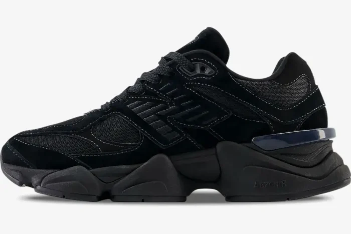 Side profile of New Balance 9060 Triple Black sneakers featuring a chunky black midsole and mesh upper. - SKU U9060BPM