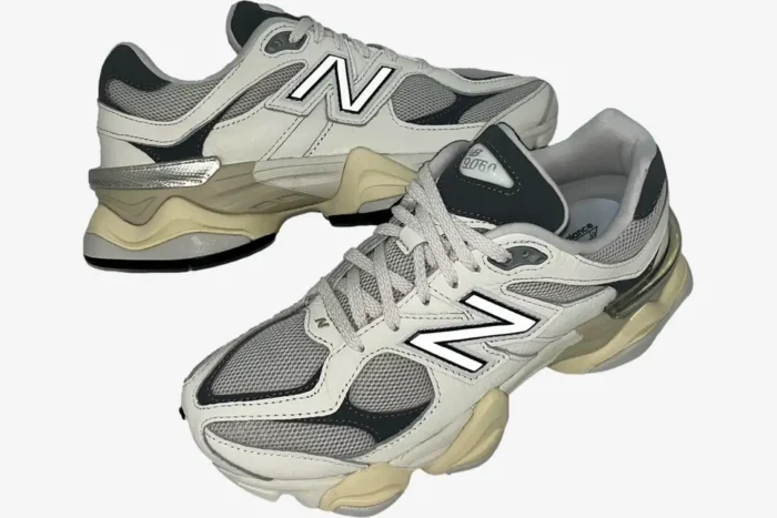 New Balance 9060 sneakers in white, grey, and beige shown from a three-quarter perspective. - SKU U9060AGAD