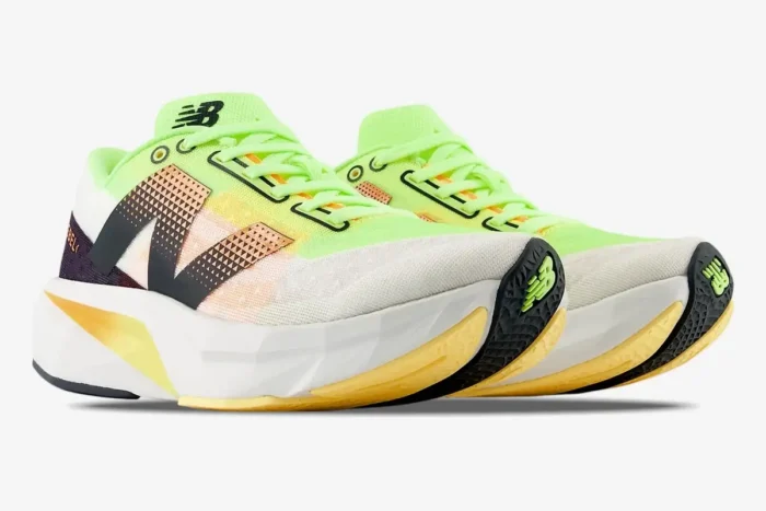 Three-quarter front view of New Balance FuelCell Rebel v4 running shoes in white and lime green. - SKU MFCXLL4