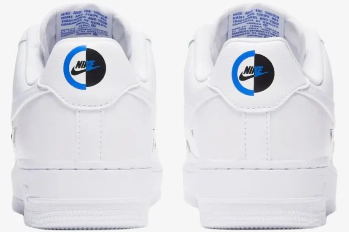 Rear view of white Nike Air Force 1 '07 LX Chrome Deluxe Women's sneakers with unique split blue and black heel logos. - SKU CT1990-100