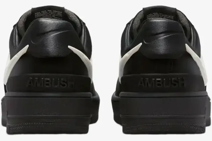 Rear view of Nike Air Force 1 Low x Ambush sneakers in black and white, featuring embossed heel branding. - SKU DV3464-001