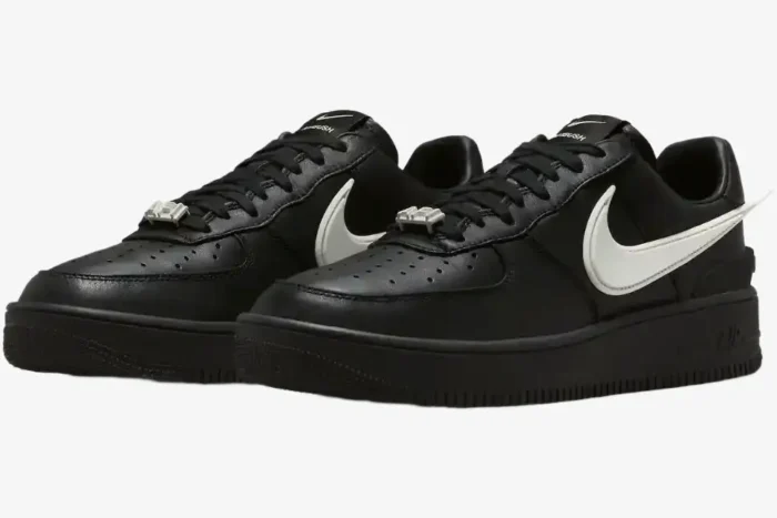 Nike Air Force 1 Low x Ambush sneakers in black and white, three-quarter front view showing extended swoosh. - SKU DV3464-001