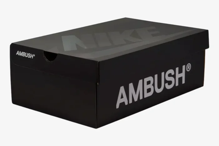 Angled view of the black Nike Air Force 1 Low x Ambush shoebox with white and glossy black logos. - SKU DV3464-300