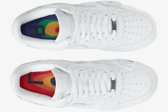 Top-down view of white Nike Air Force 1 Low x CPFM sneakers showing colorful insoles and oversized lettering. - SKU FQ7069100