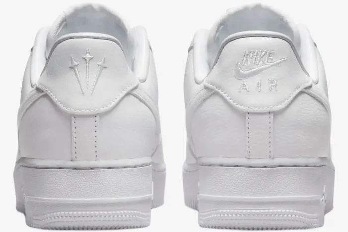 Rear view of white Nike Air Force 1 Low x NOCTA sneakers featuring embroidered heel logos. - SKU CZ8065-100