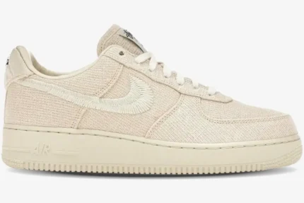 Side profile of Nike Air Force 1 Low x Stussy Fossil Stone sneaker with woven upper and embroidered Swoosh. - SKU CZ9084-200