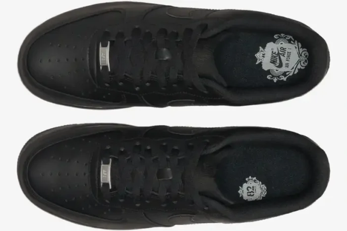 Top-down view of black Nike Air Force 1 Low x Supreme sneakers with silver dubrae and branded insoles. - SKU CW2288-001