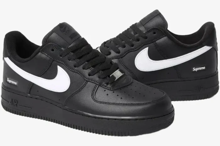 Pair of Nike Air Force 1 Low x Supreme Black White sneakers shown from a three-quarter perspective. - SKU SP1AF11