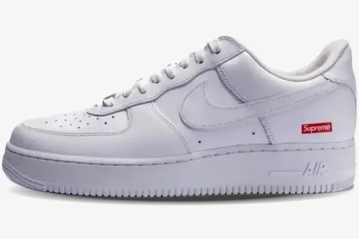 Side profile of Nike Air Force 1 Low x Supreme White sneakers featuring a red box logo on the heel. - SKU CU9225-100