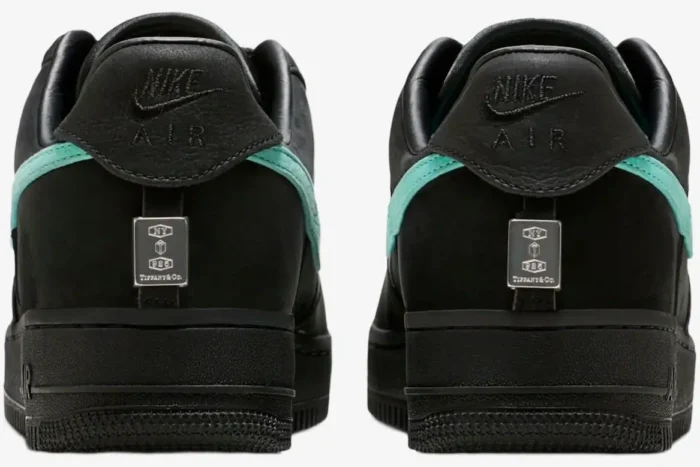 Rear view of black Nike Air Force 1 Low x Tiffany & Co. 1837 sneakers with silver heel plates and teal swooshes. - SKU DZ1382-001
