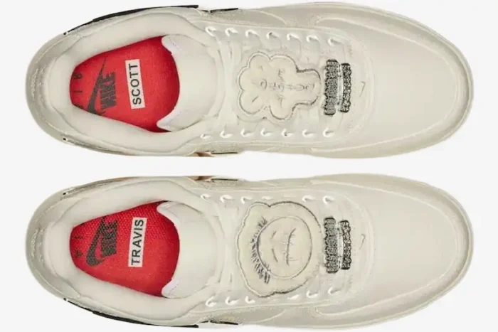 Top-down view of Nike Air Force 1 Low x Travis Scott 'Sail' sneakers with red insoles and decorative lace patches. - SKU AQ4211-101