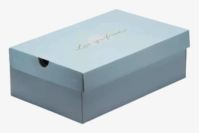 Light blue Nike Air Force 1 Low x NOCTA shoebox with gold 'Love you forever' script, three-quarter view. - SKU CZ8065-100