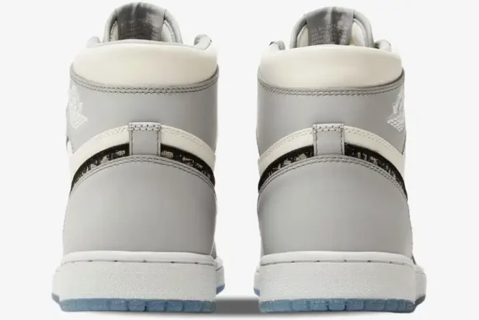 Rear view of Air Jordan 1 Retro High x Dior sneakers in grey and white with monogram swoosh. - SKU CN8607-002
