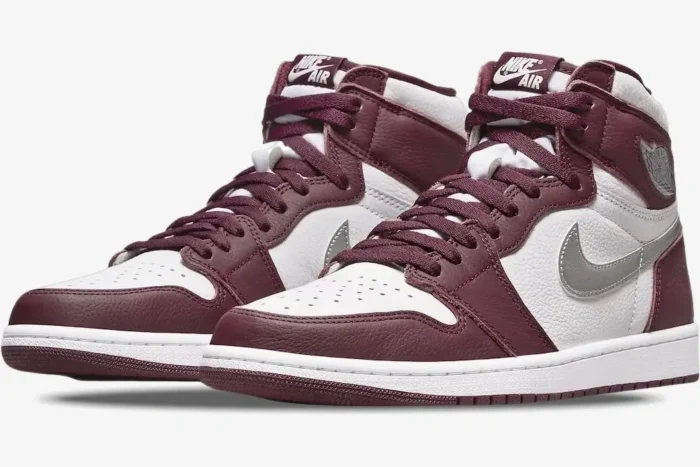 Three-quarter view of Air Jordan 1 High OG Bordeaux sneakers in white and maroon leather with silver Swoosh. - SKU 555088-611
