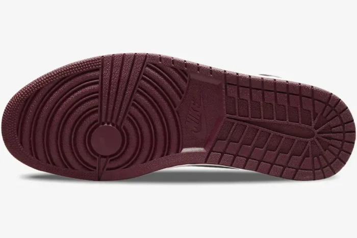 Bottom view of the Air Jordan 1 High OG Bordeaux sneaker showing the maroon rubber outsole and traction pattern. - SKU 555088-611