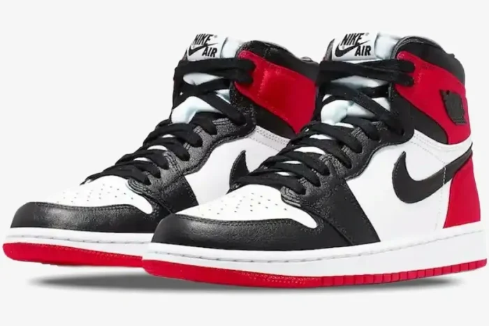 Air Jordan 1 High OG 'Bred Toe' sneakers in red, black, and white, shown from a three-quarter front angle. - SKU 555088-610