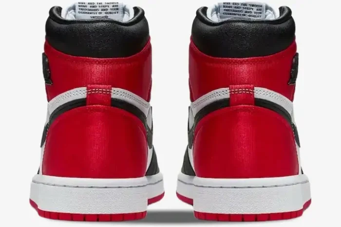 Rear view of Air Jordan 1 High OG 'Bred Toe' sneakers featuring red satin heels and white midsoles. - SKU 555088-610