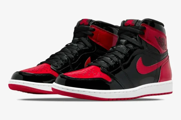 Air Jordan 1 High OG Patent Bred sneakers in black and red patent leather, three-quarter front view. - SKU 555088-063