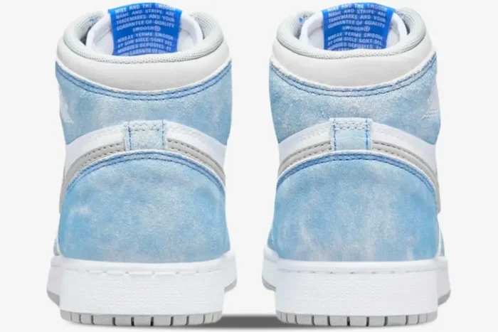 Back view of Air Jordan 1 Retro High OG Hyper Royal shoes featuring washed blue suede and white leather accents. - SKU 555088-402