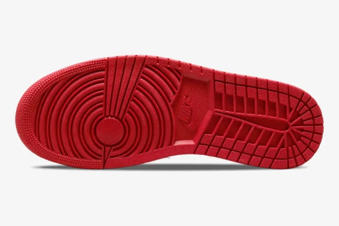 Red rubber outsole of the Air Jordan 1 Low Black Toe sneaker, bottom view. - SKU 553558-116