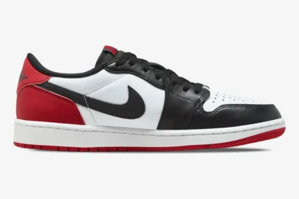 Side profile of Air Jordan 1 Low Black Toe sneakers in white, black, and red leather. - SKU 553558-116