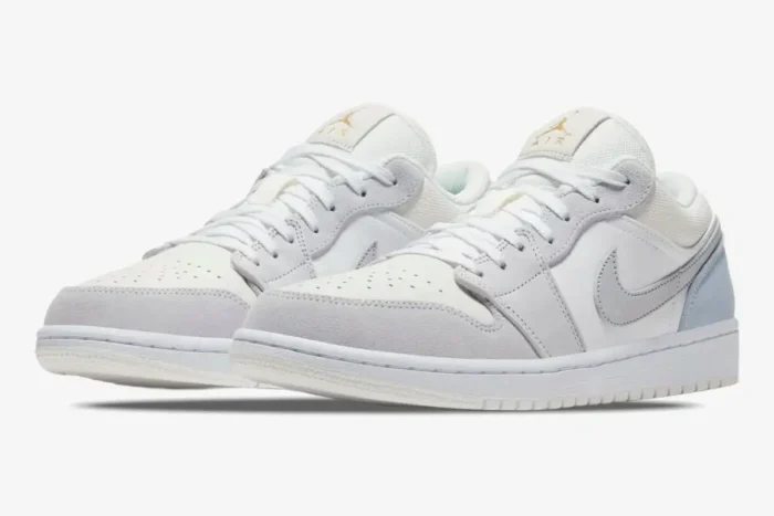 Air Jordan 1 Low Paris City Pack sneakers in white and light grey, shown from a three-quarter front perspective. - SKU CV3043-100