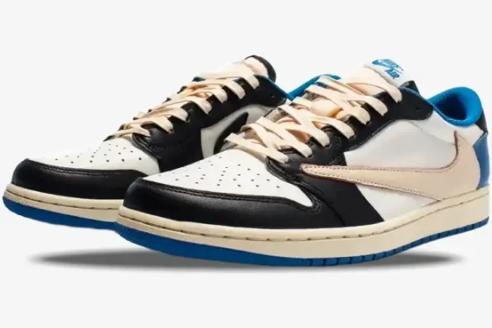 Nike Air Jordan 1 Low OG x Travis Scott x Fragment sneakers in white, black, and blue, three-quarter front view. - SKU DM7866-140