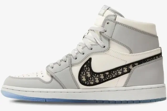 Side profile of the Air Jordan 1 Retro High x Dior sneaker in grey and white with monogram Swoosh. - SKU CN8607-002