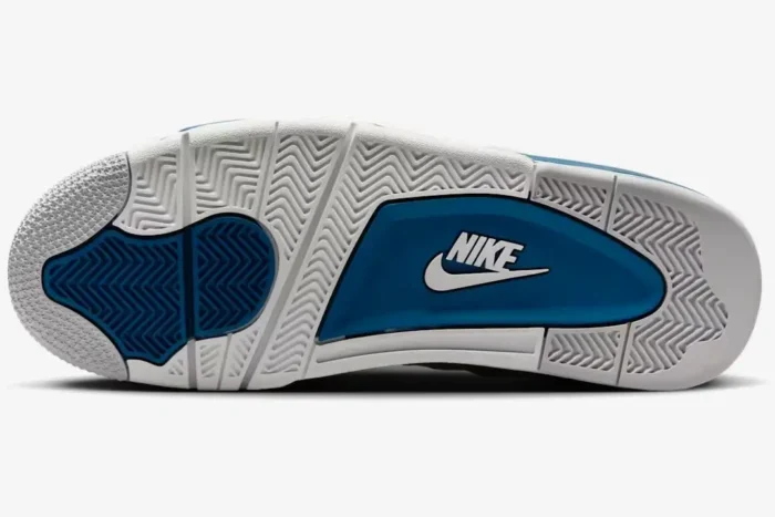 Bottom outsole view of Air Jordan 4 Retro Industrial Blue featuring white and blue herringbone traction patterns. - SKU FV5029-141