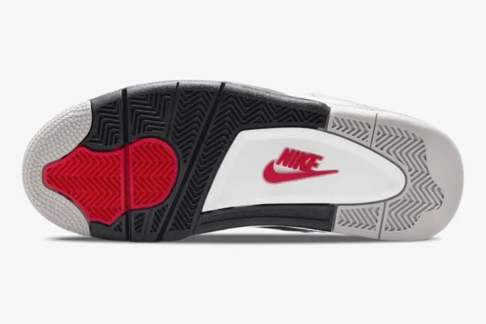 Outsole view of Air Jordan 4 Retro White Cement featuring grey, black, and red traction patterns with Nike logo. - SKU 840606-192