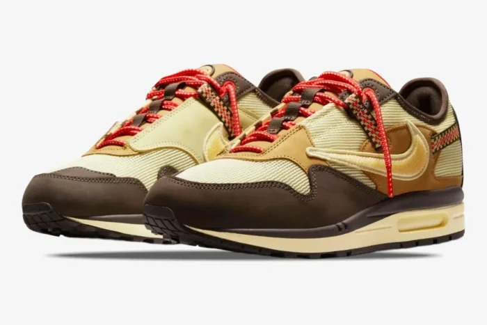 Nike Air Max 1 x Cactus Jack Baroque Brown sneakers featuring a reversed swoosh and red laces, three-quarter view. - SKU DO9392-200