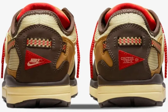 Rear view of Nike Air Max 1 x Cactus Jack Baroque Brown sneakers featuring red Nike and Cactus Jack heel patches. - SKU DO9392-200