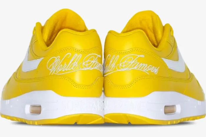 Rear view of yellow Nike Air Max 1 x Supreme sneakers with white World Famous embroidery and Supreme midsole branding. - SKU HF8813-700